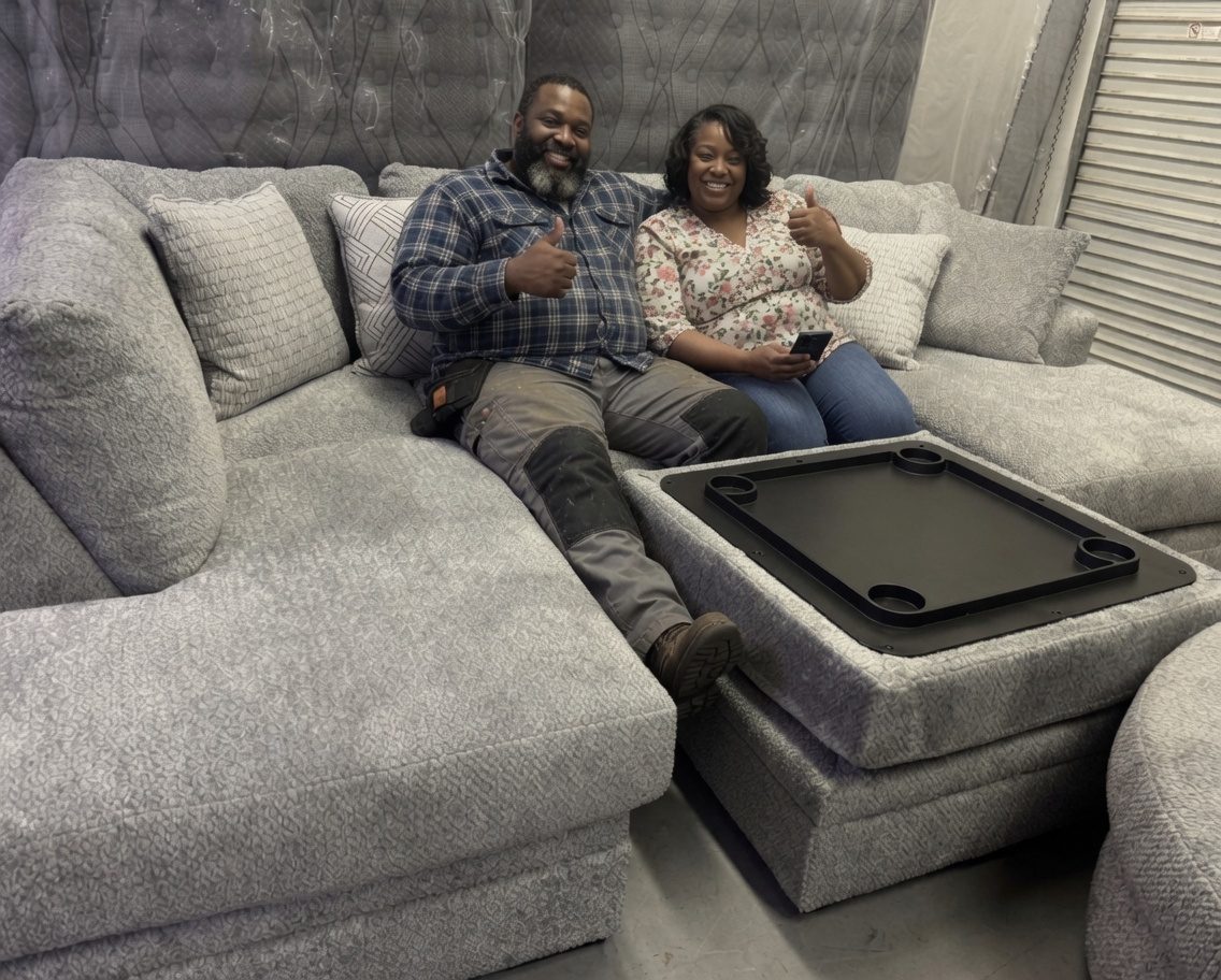 Happy customers with new furniture at the best furniture store in Elk Grove giving a thumbs up