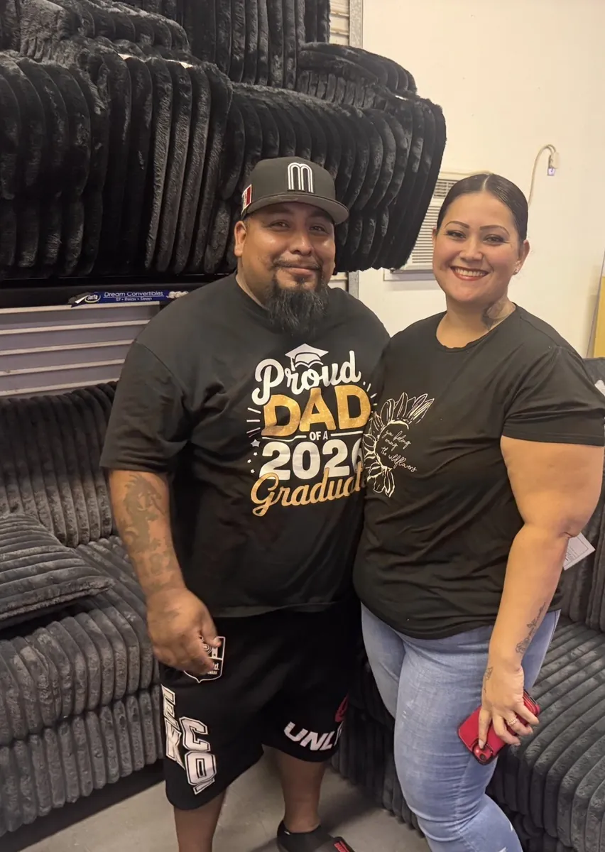 Couple with a new sectional at our Elk Grove showroom