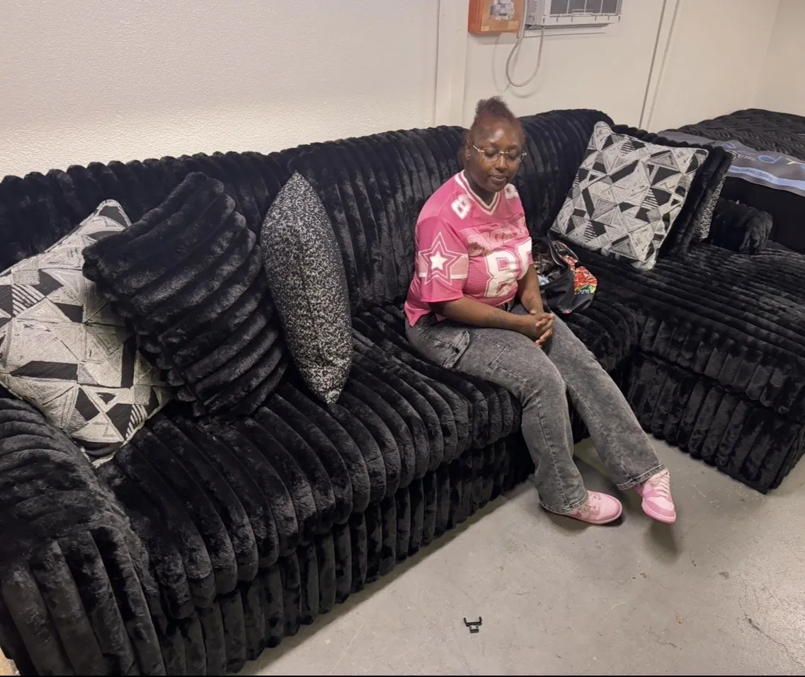 Customer with a black plush sectional at our Elk Grove showroom