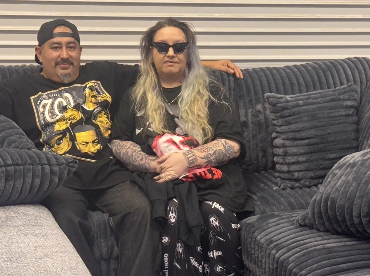 Happy customers with their new gray sectional at our Elk Grove furniture store
